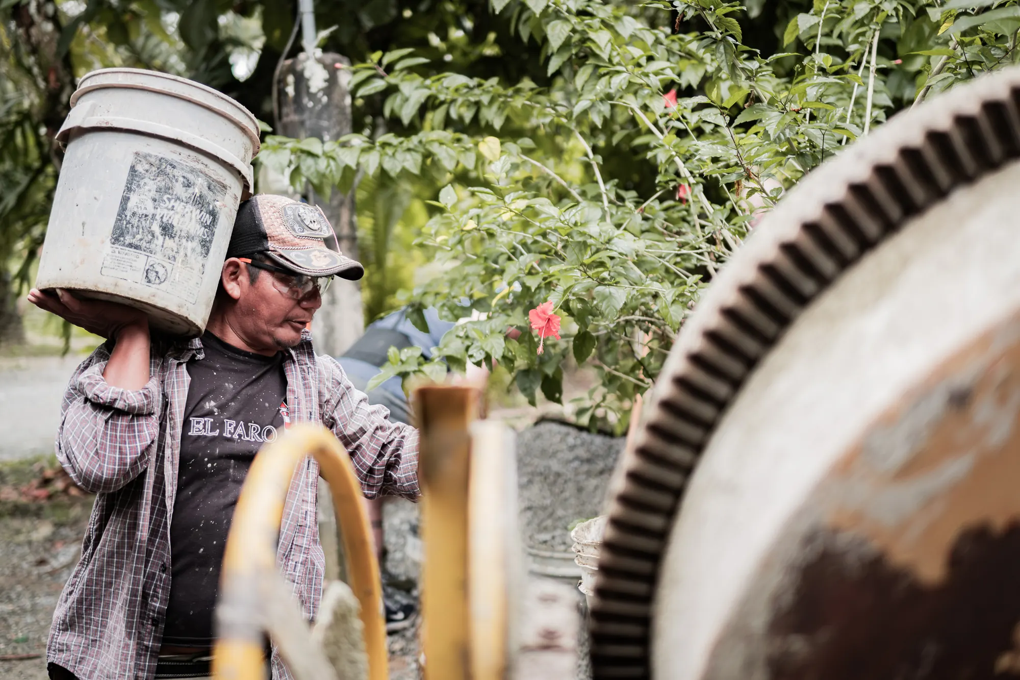 A team member carries materials during an El Faro construction project.