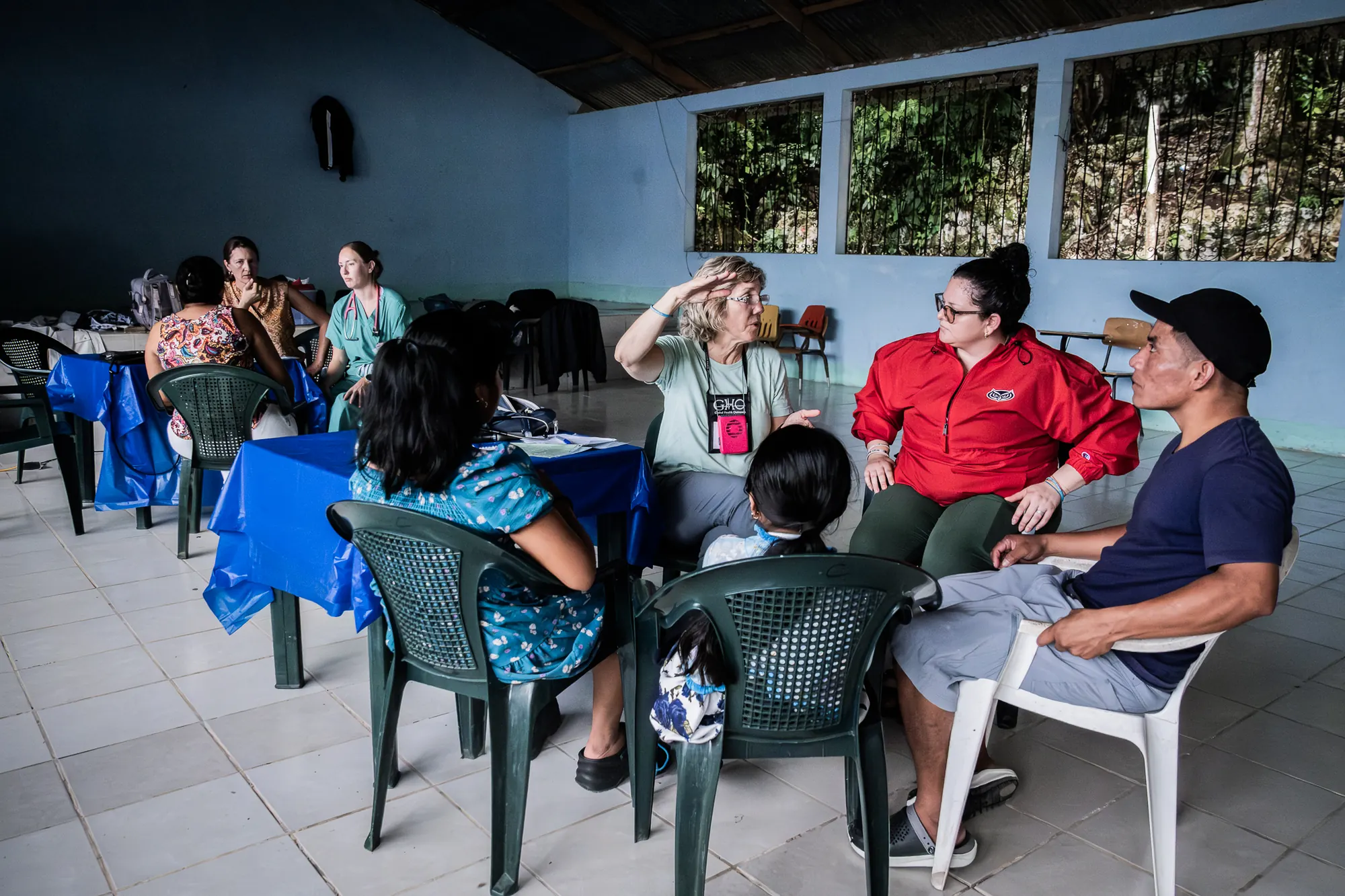 Healthcare volunteers listen to residents during a community clinic.