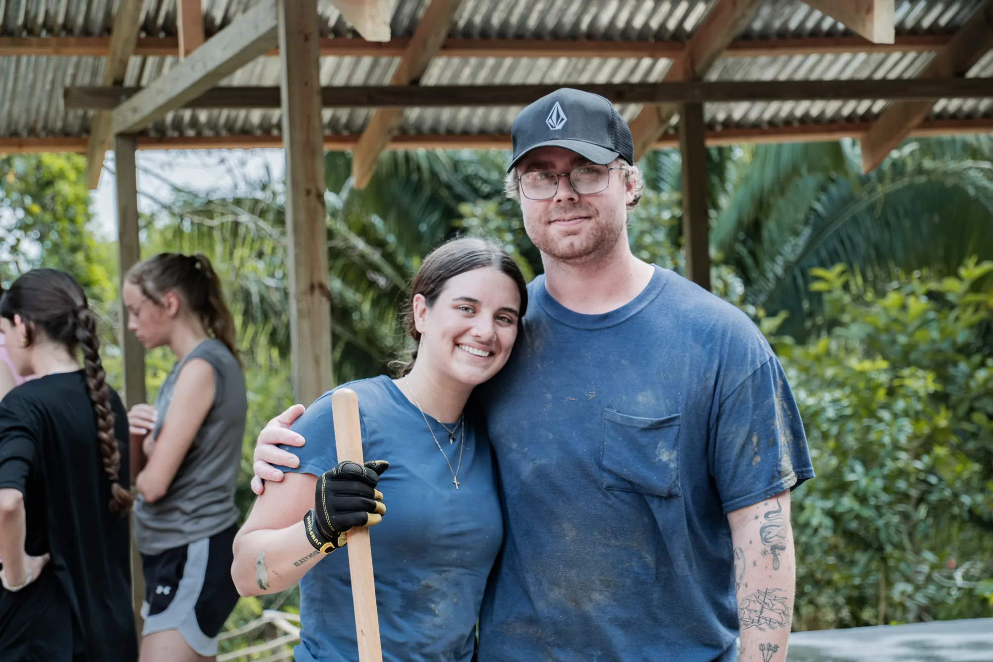 A volunteer smiles after serving alongside an El Faro team.