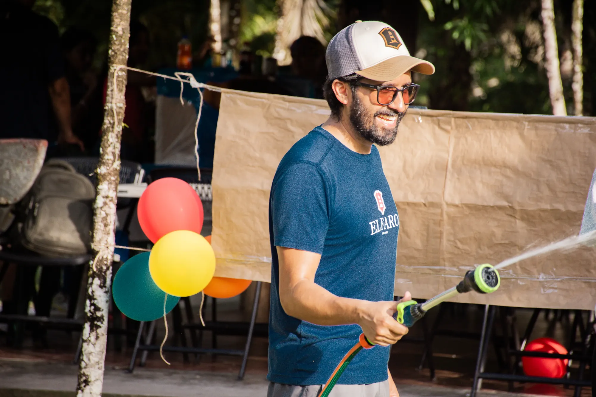 An activity leader encourages children during a family field day.