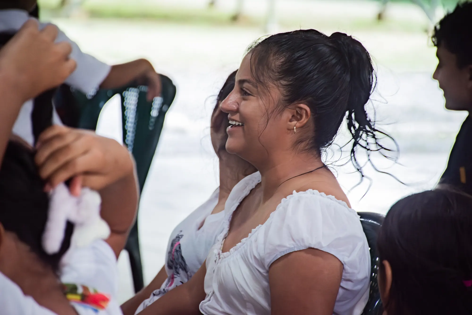 A child smiles with a family member during an El Faro gathering.