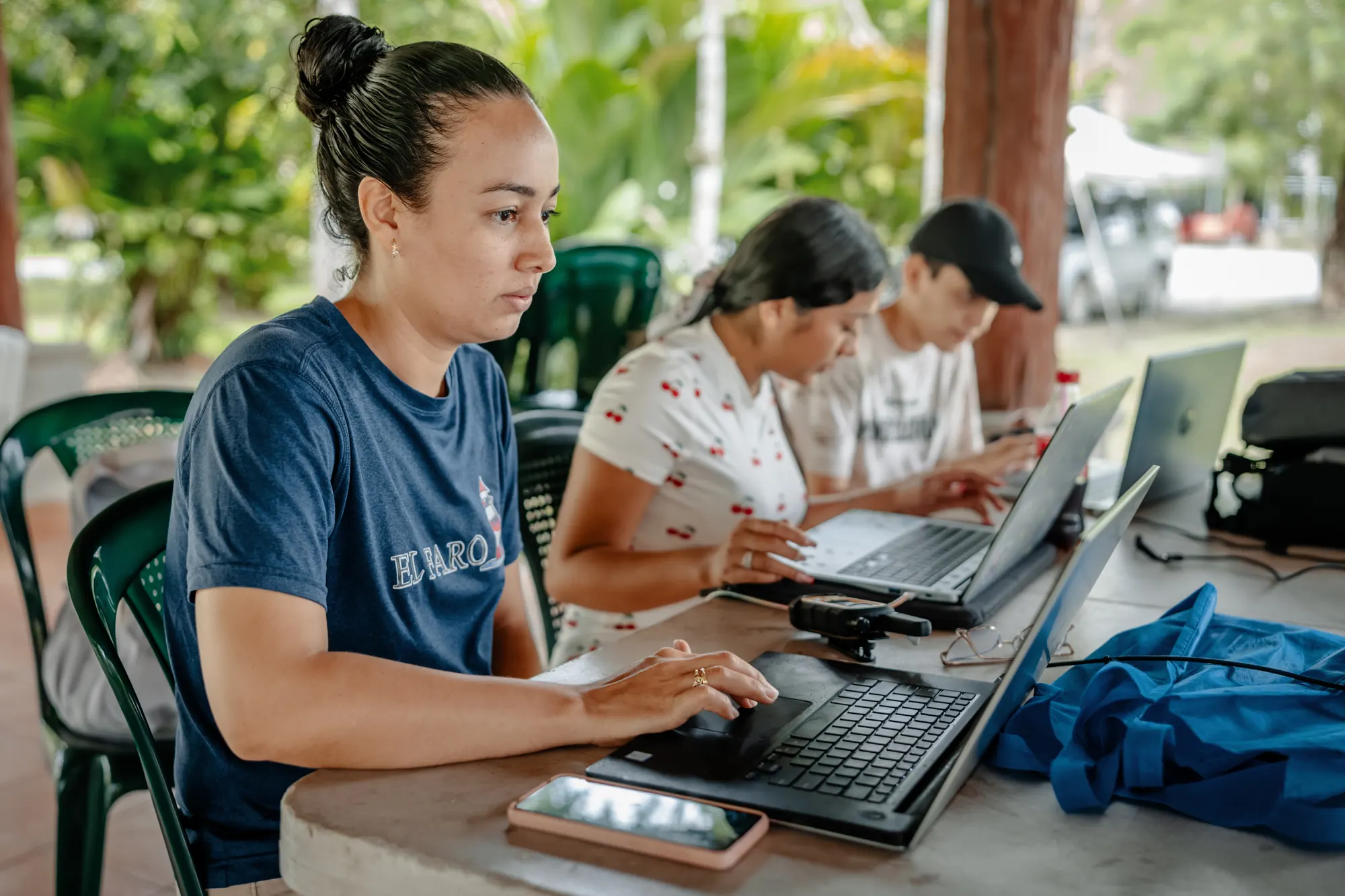 An adult education student completes coursework on a laptop at El Faro.