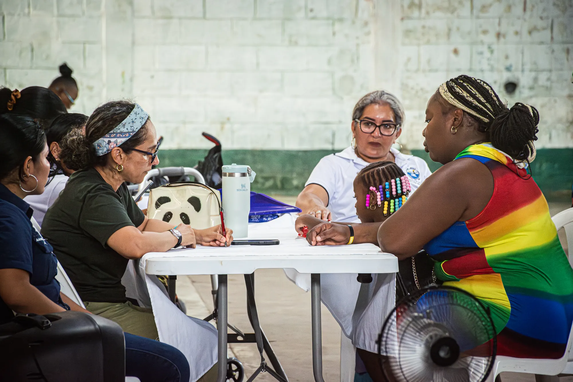 Community members and volunteers talk together during regional outreach.