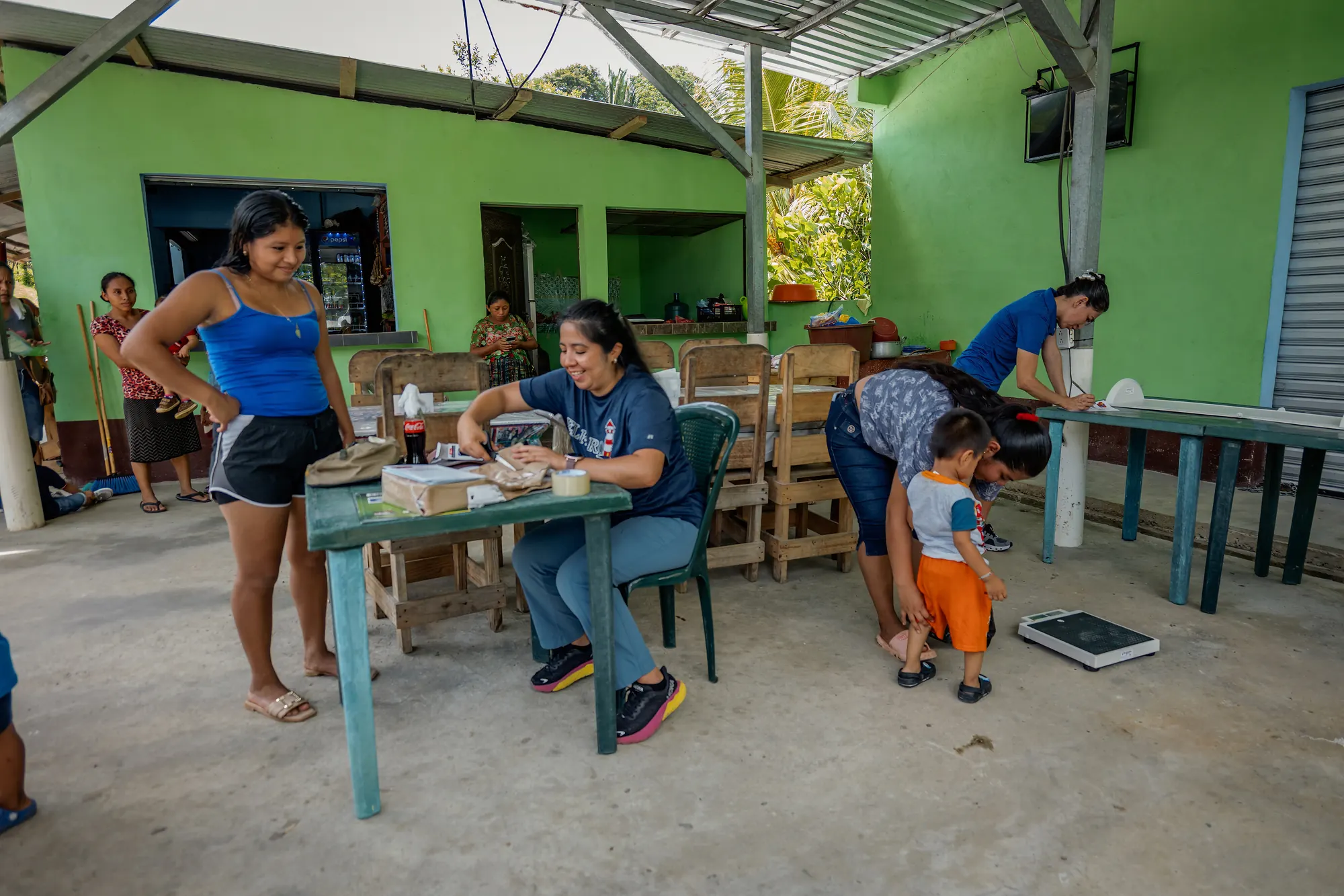 Families check in during a community nutrition program.
