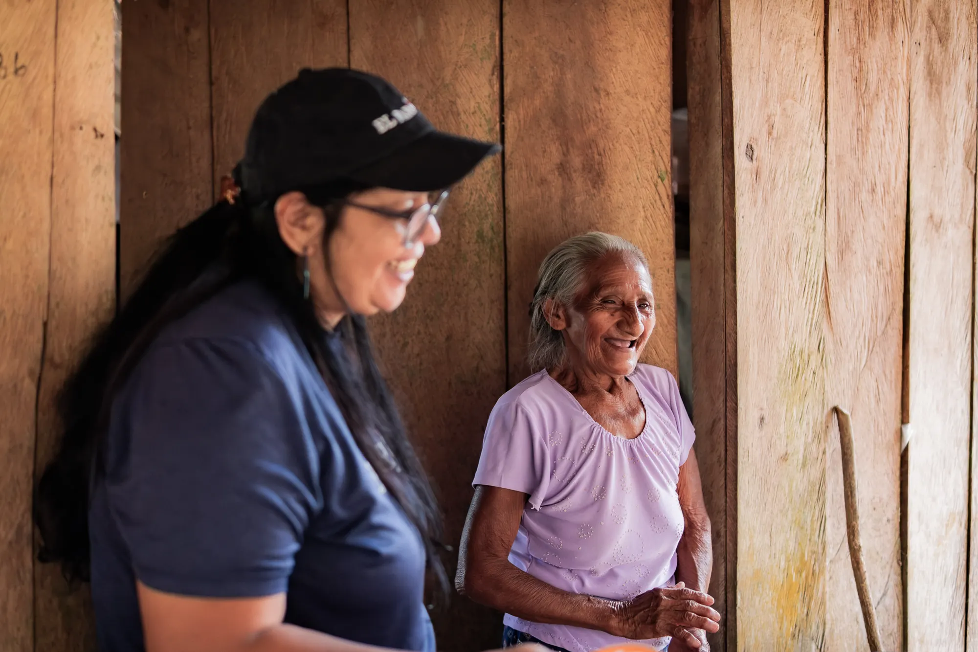 A visiting volunteer spends time with a local resident in Guatemala.
