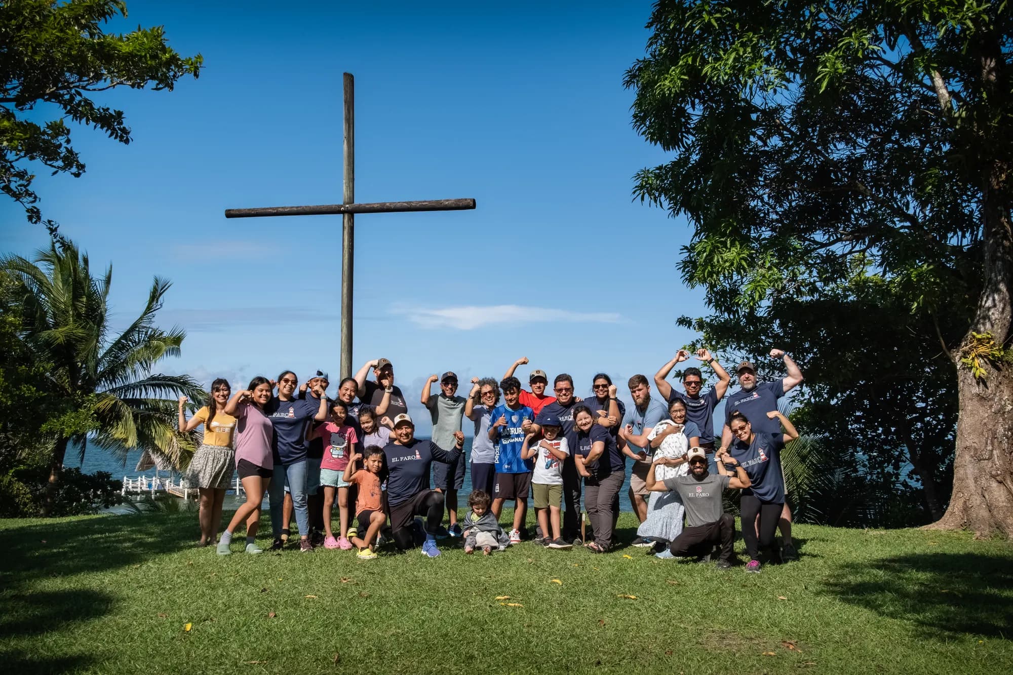 El Faro staff and families gather beneath the campus cross.