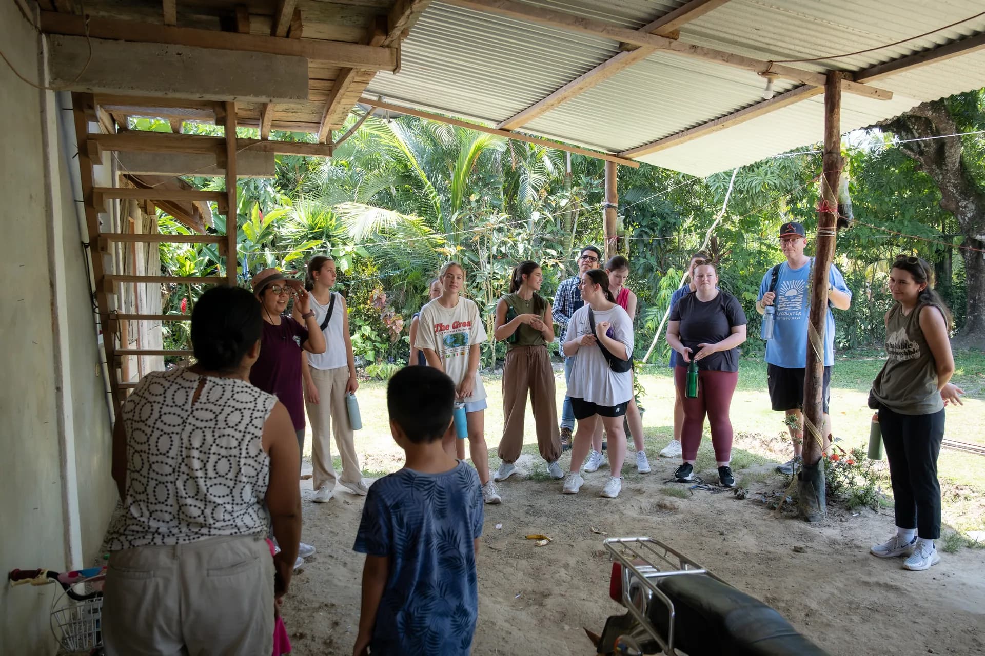 El Faro volunteers and local families gather at a home in Guatemala.