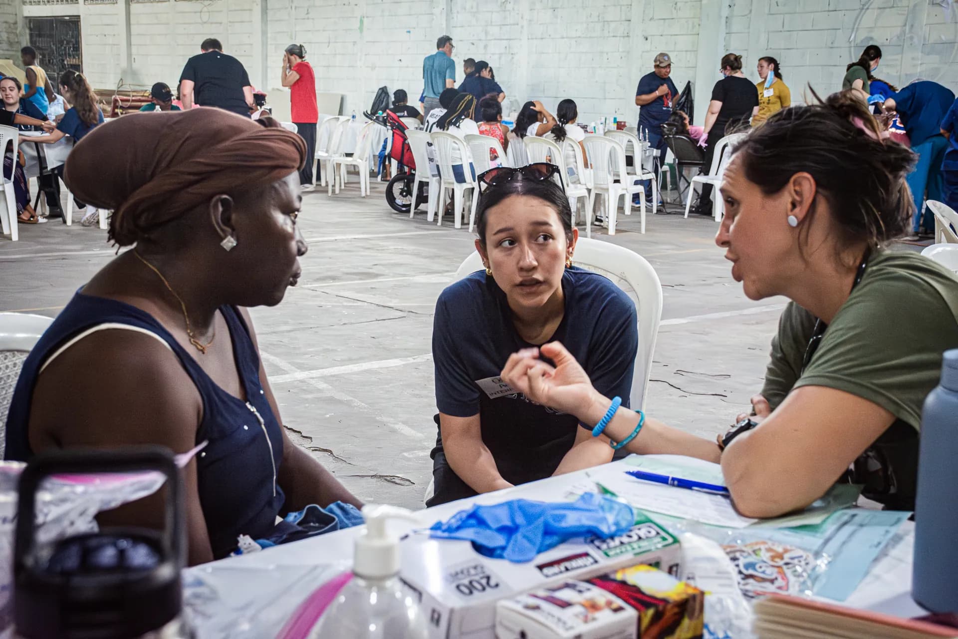 Medical mission team members speak with a patient during a community consultation.