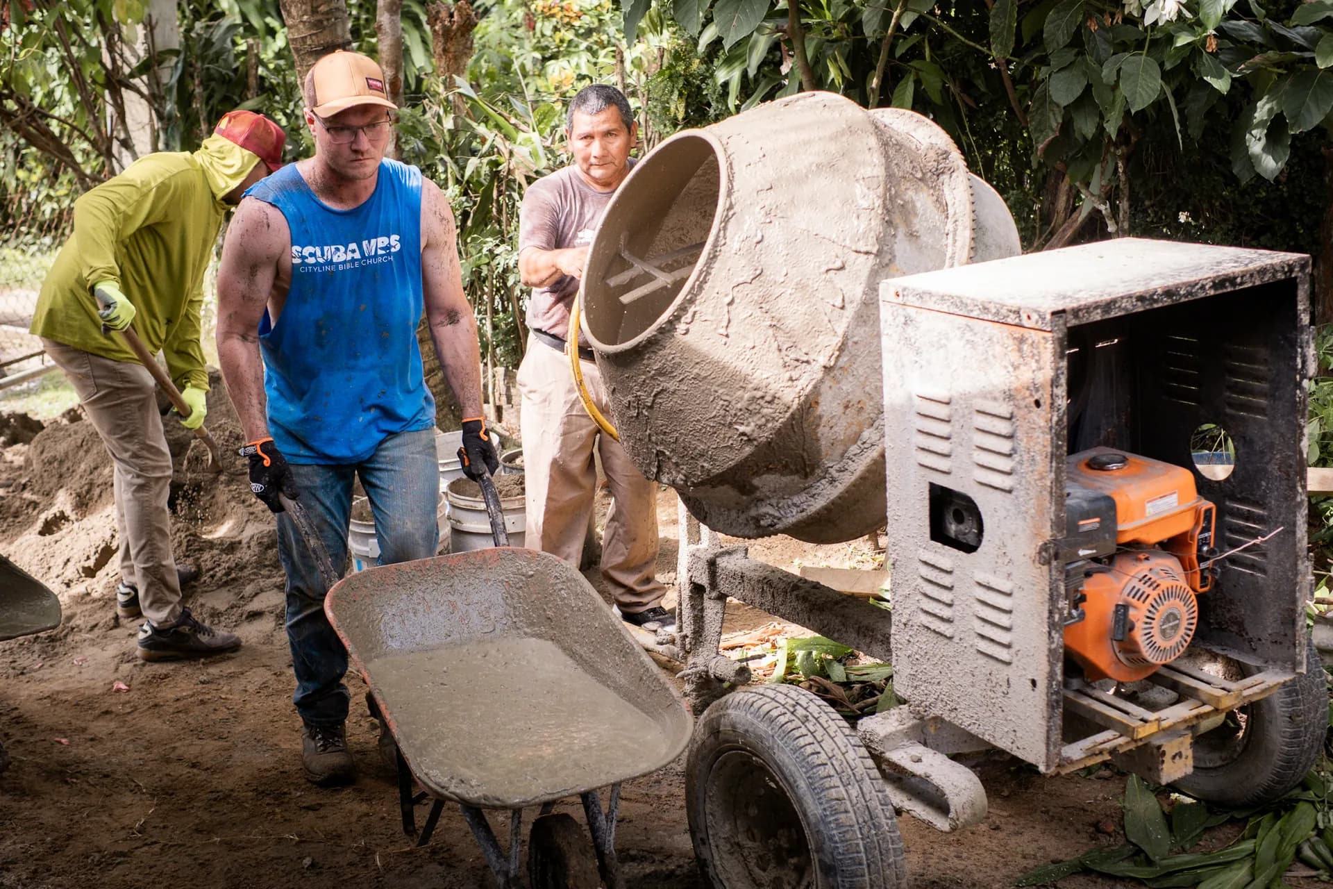 A mission team mixes concrete for a community construction project in Guatemala.