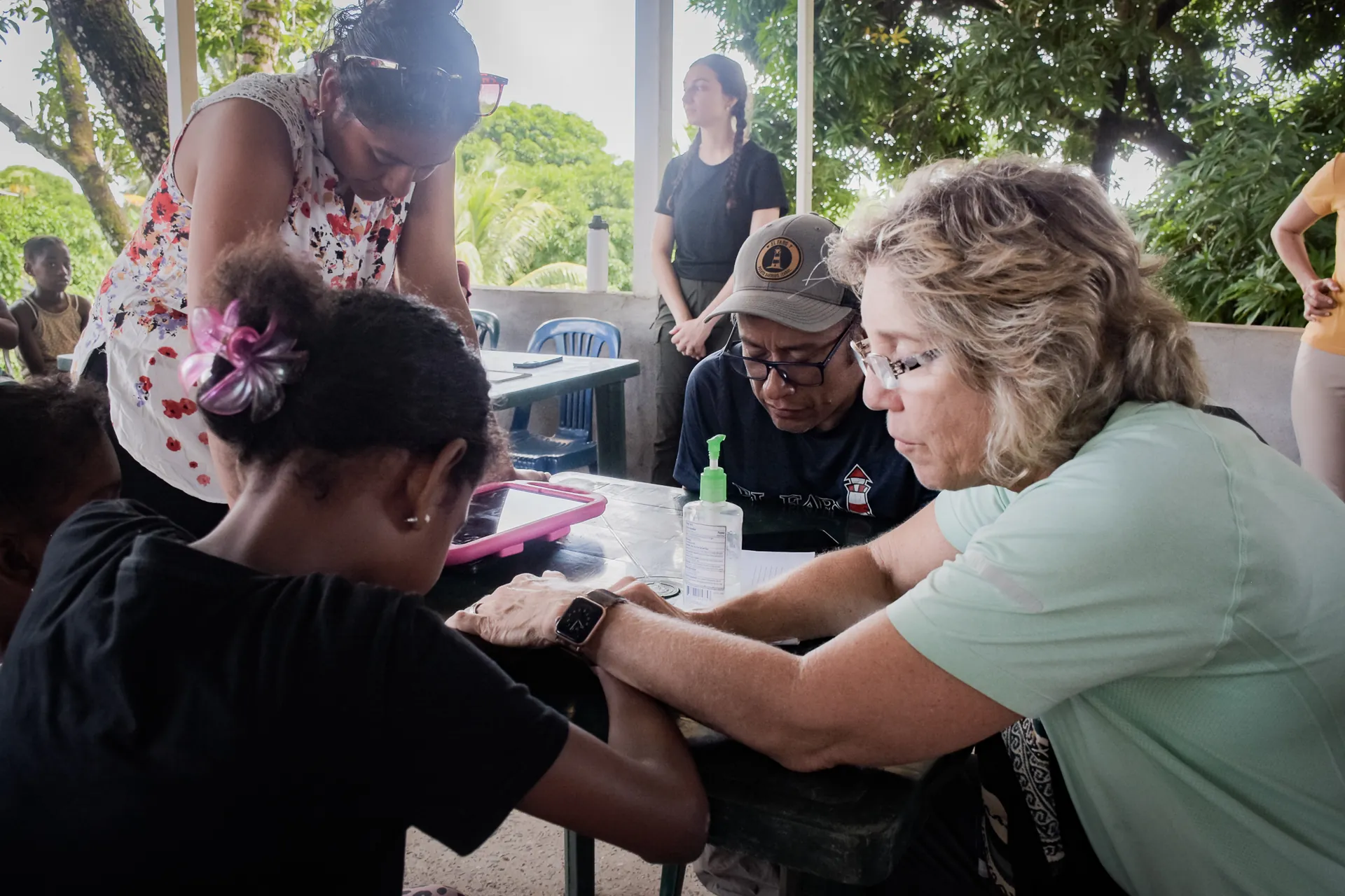 A healthcare volunteer listens to a patient during a community medical clinic.