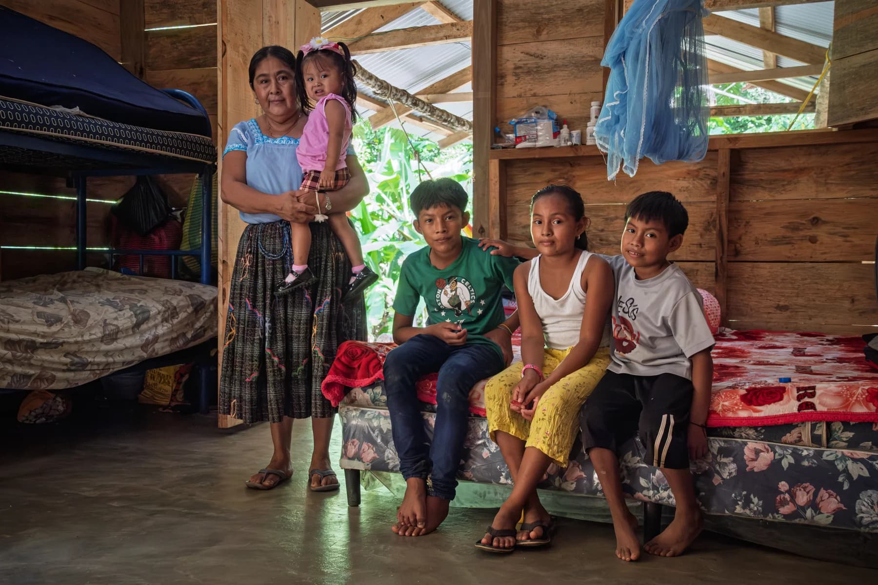 A family gathers inside their wooden home.