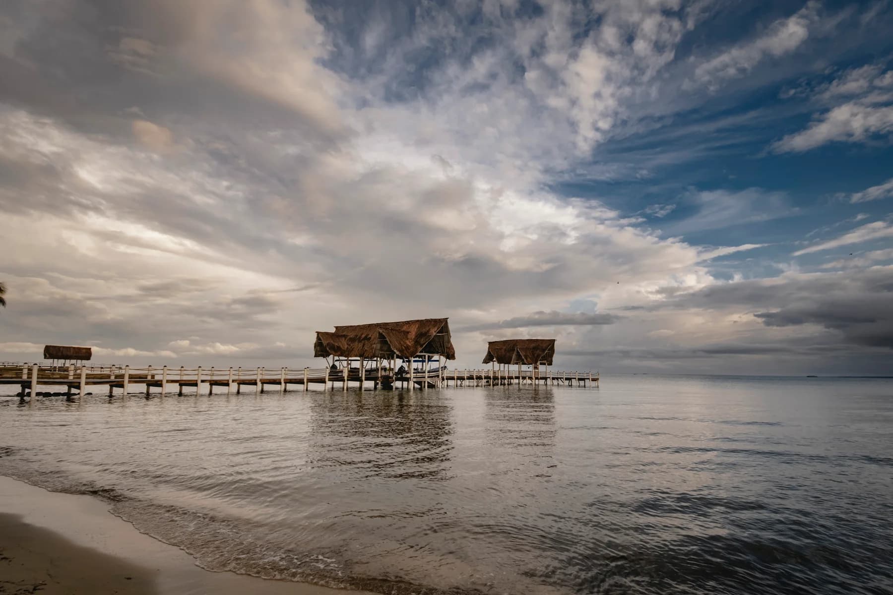 The El Faro dock beneath a cloudy Caribbean sky.