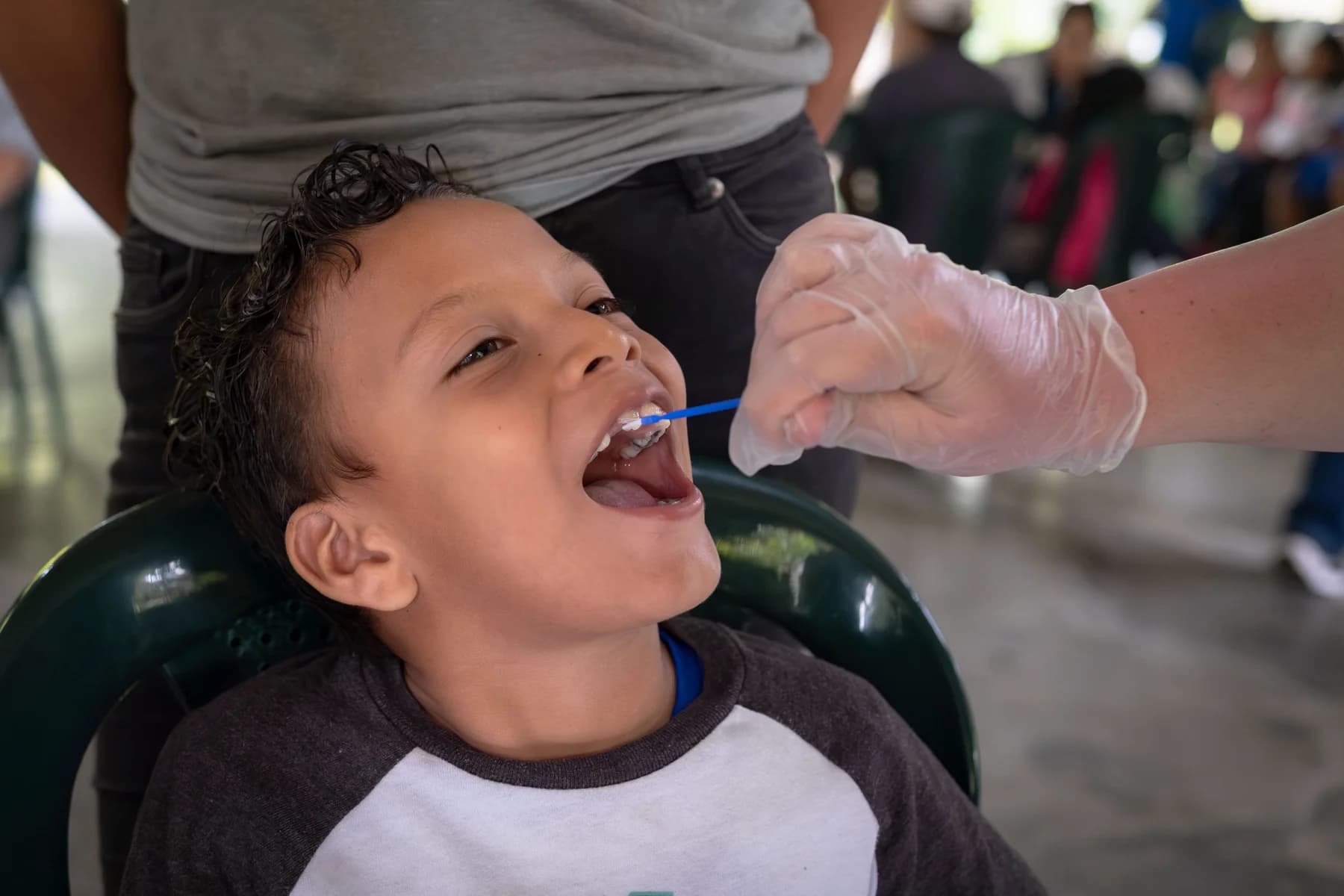 A child receives dental care during an El Faro clinic.