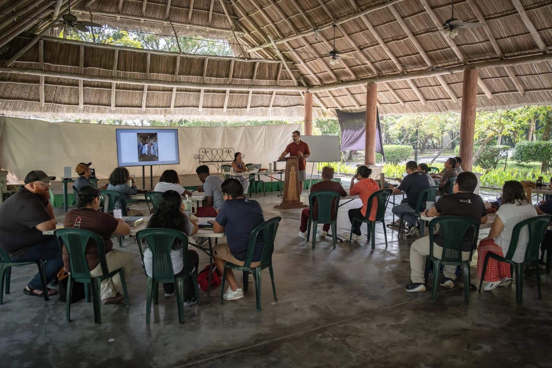 A group meets inside the open-air El Faro pavilion.