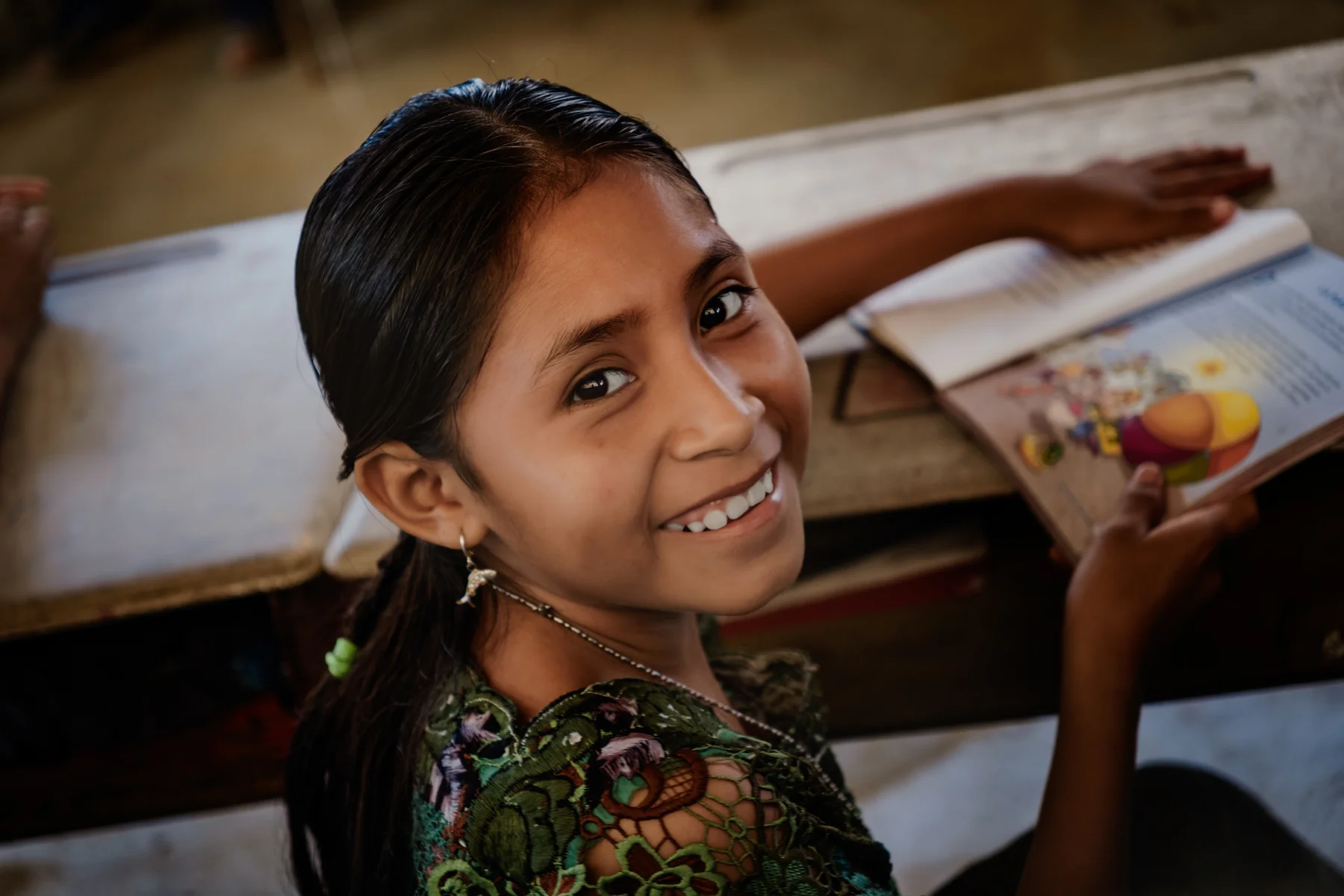 A girl smiles during an activity in El Naranjal.