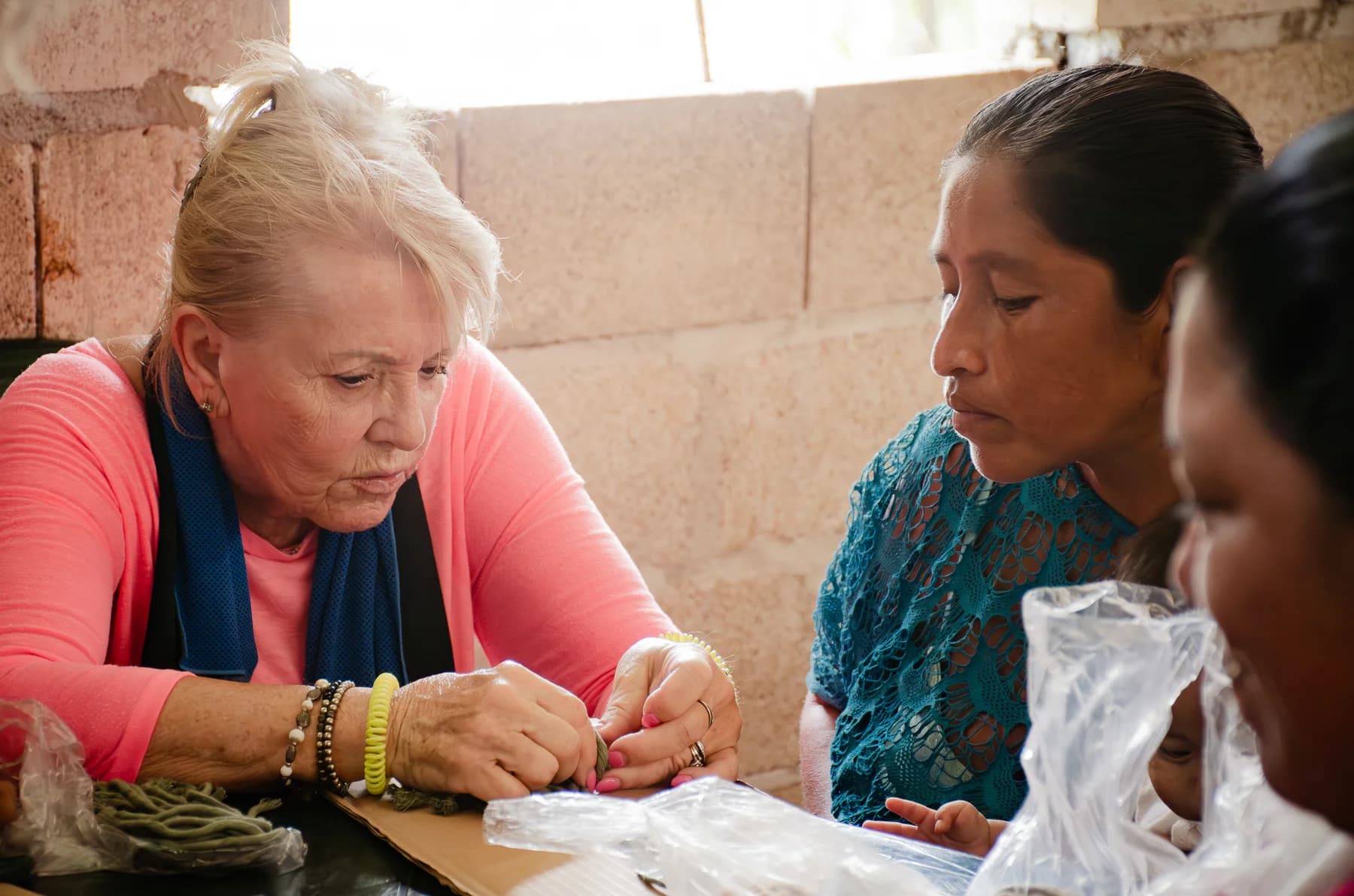 A volunteer and a community member work together at a table.