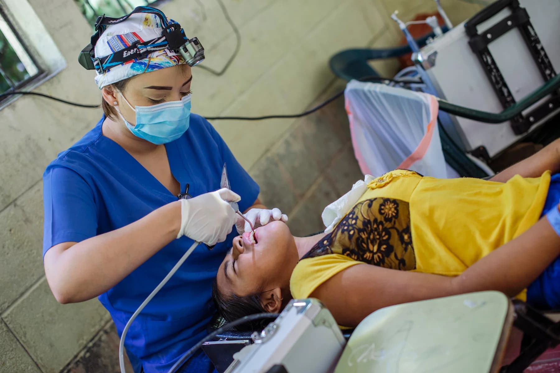 A dental professional treats a patient at El Faro.