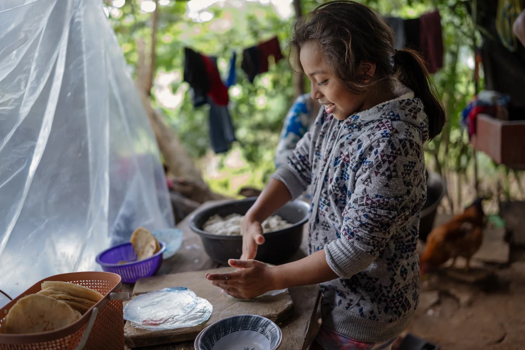 A woman prepares food in a community kitchen.