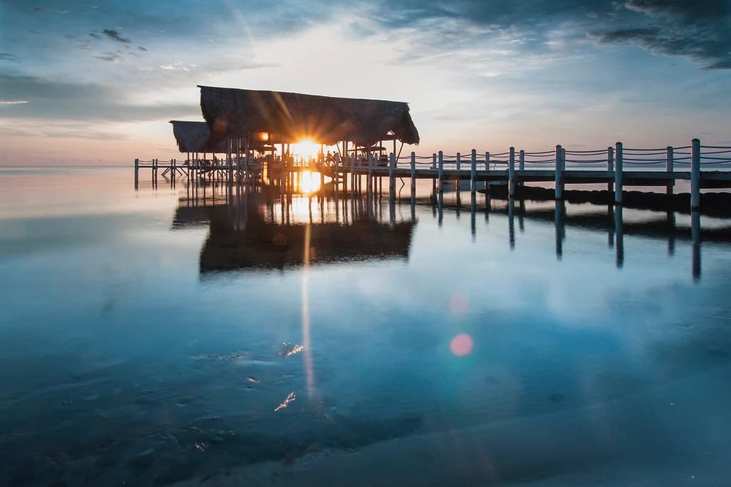 Sunset reflects around the El Faro dock.