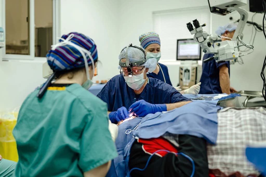 An eye surgery team cares for a patient.