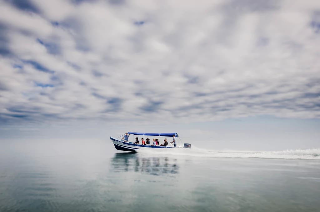 An El Faro boat crosses calm Caribbean waters.